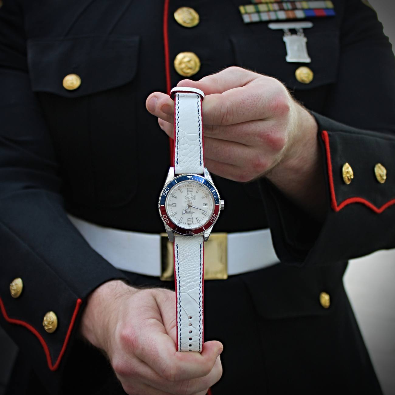 America 250 SS-1 held up by a Marine in dress blues