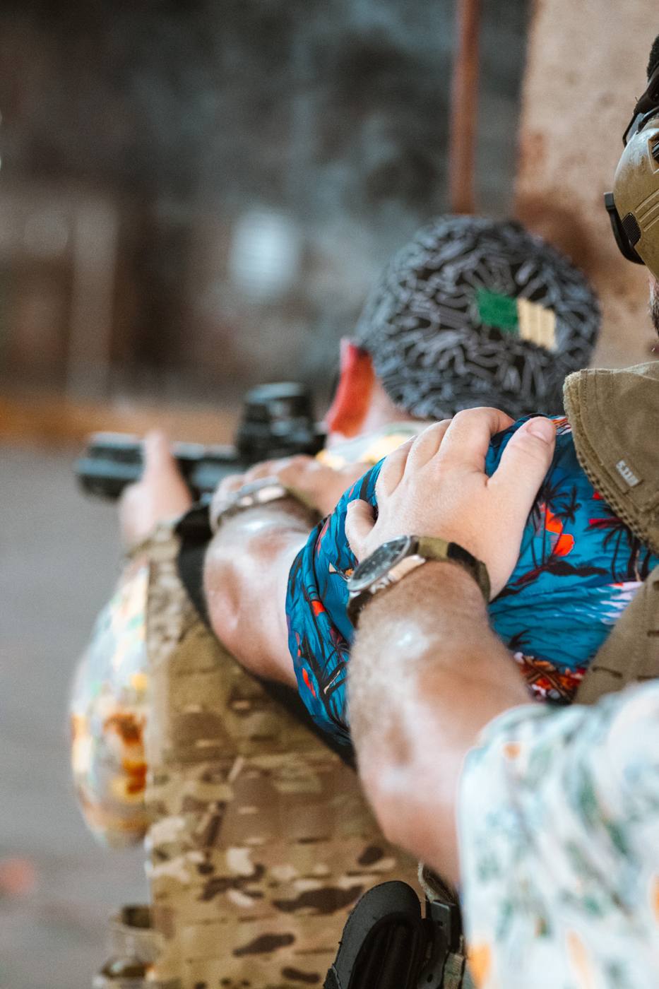 SWCS watches on olive nylon straps resting on a gun case