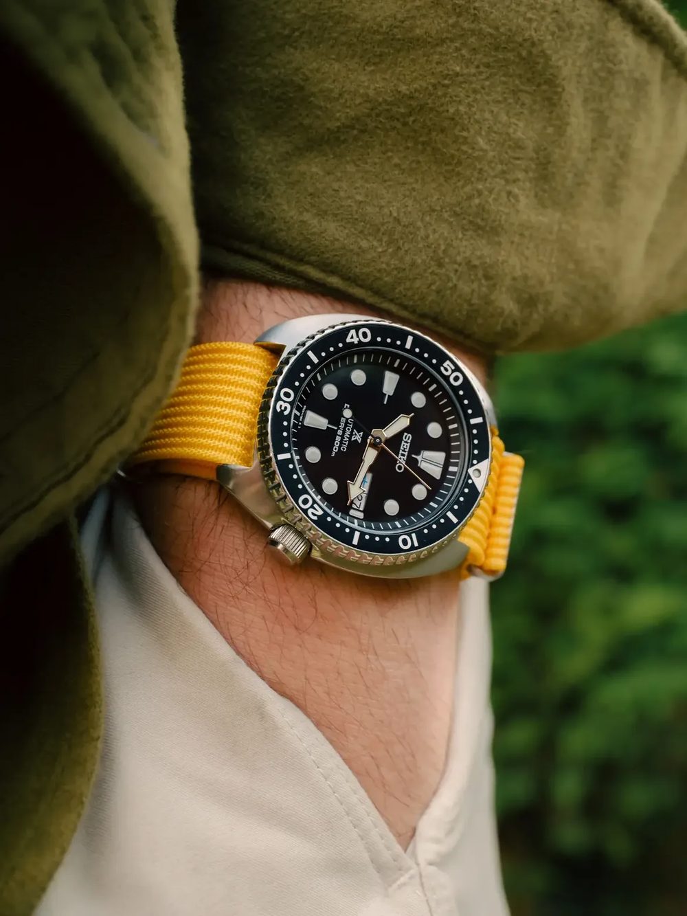 WIS yellow woven nylon watch strap worn on the wrist